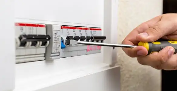 electrical panel upgrade service showing technician adjusting circuit breakers during system upgrade in Lancaster, PA