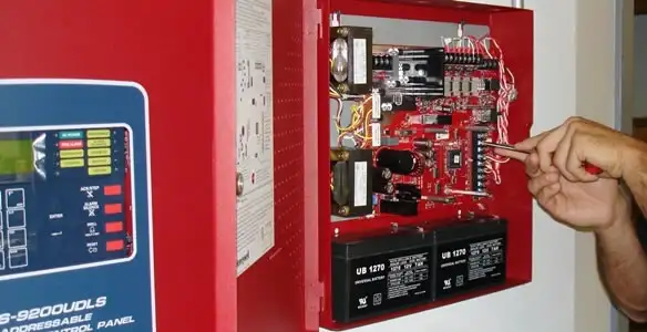 fire alarm installation service showing technician configuring fire alarm control panel in Lancaster, PA