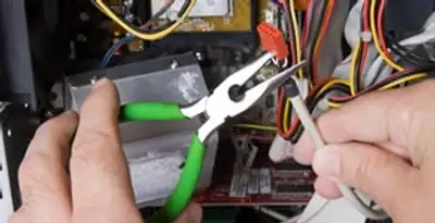 Licensed electrical contractor performing electrical repair with tools in Willow Street, PA