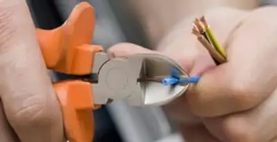 professional electrical services showing precise wire cutting by licensed electricians in Lancaster, PA
