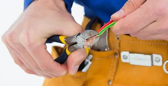 licensed electrician securing electrical wiring with professional tools during service work in Lancaster, PA
