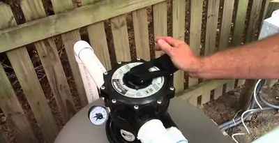 pool pumps service showing professional adjustment of pool pump control system in Lancaster, PA