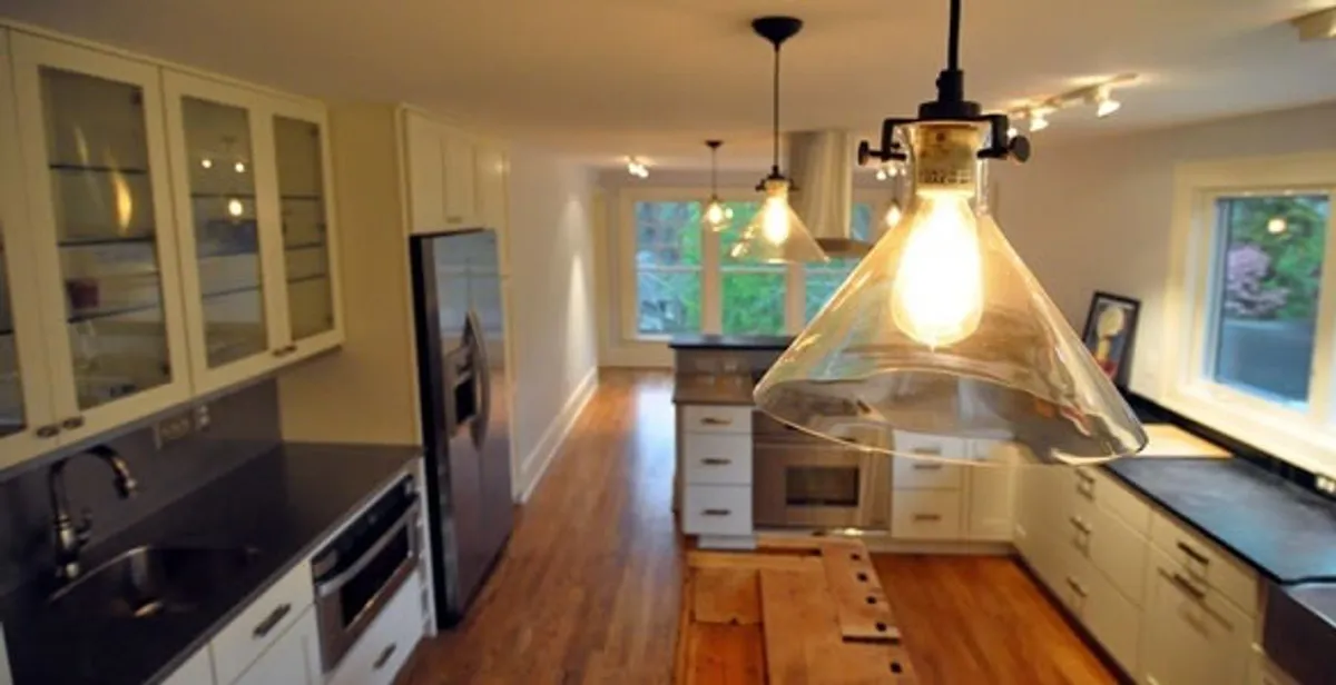 Residential electrician installing modern indoor light fixture in a home in Lancaster, PA