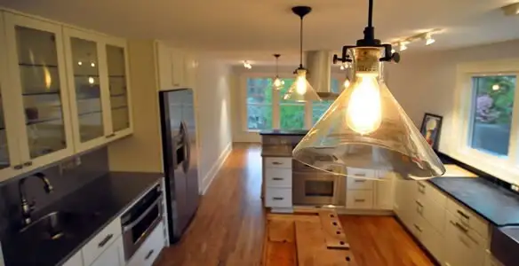 Residential electrician installing modern indoor light fixture in a home in Lancaster, PA