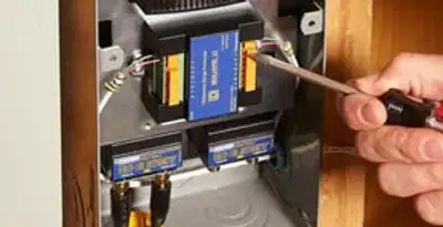 Whole home surge protection device being installed by a licensed electrician to protect electrical systems in Lancaster, PA